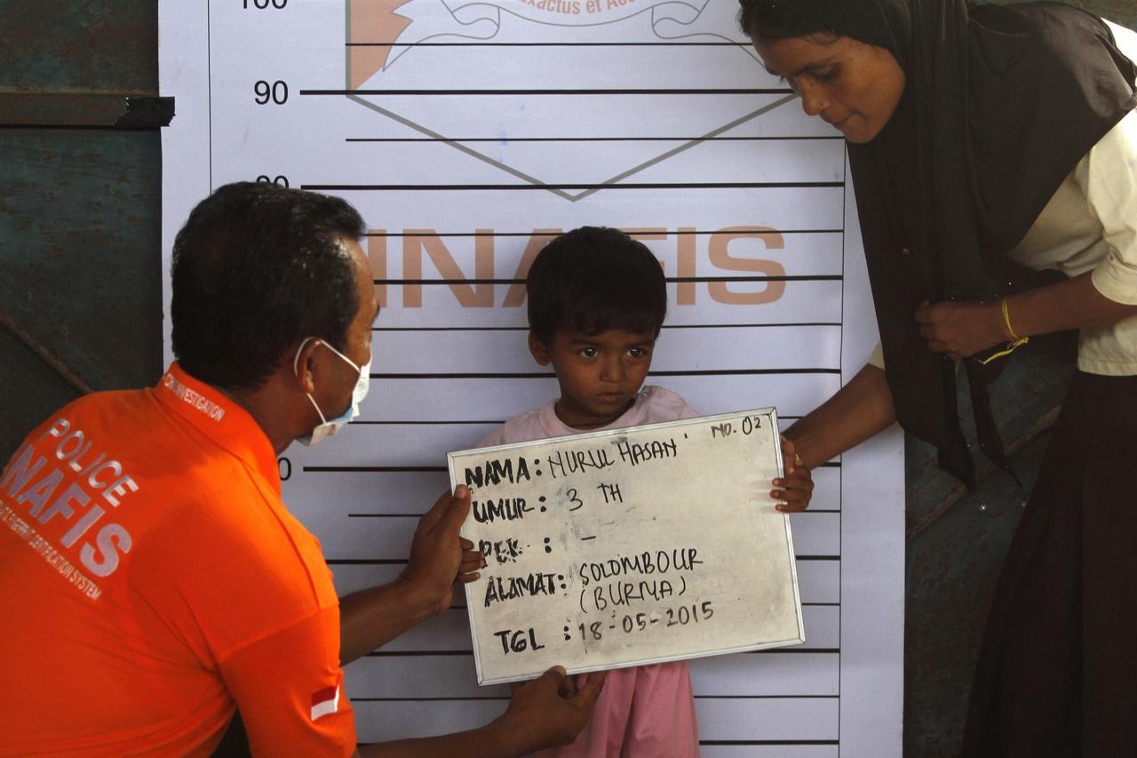A Rohingya child who recently arrived by boat has his picture taken for identification purposes at a shelter in Kuala Langsa, in Indonesia's Aceh Province, May 18, 2015. The United Nations has called on Southeast Asian nations not to push back the boatloa