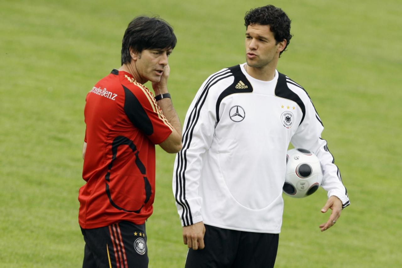 'File picture shows Michael Ballack (R) as he talks to coach Joachim Loew before a training session of the German national soccer team in Homburg May 26, 2008. Germany captain Michael Ballack\'s inter