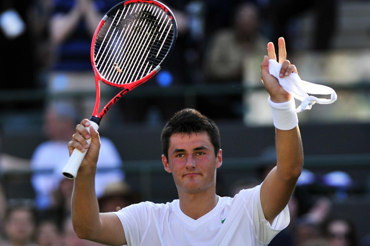 'Australian player Bernard Tomic reacts after beating Swedish player Robin Soderling during the men\'s single at the Wimbledon Tennis Championships at the All England Tennis Club, in southwest London 