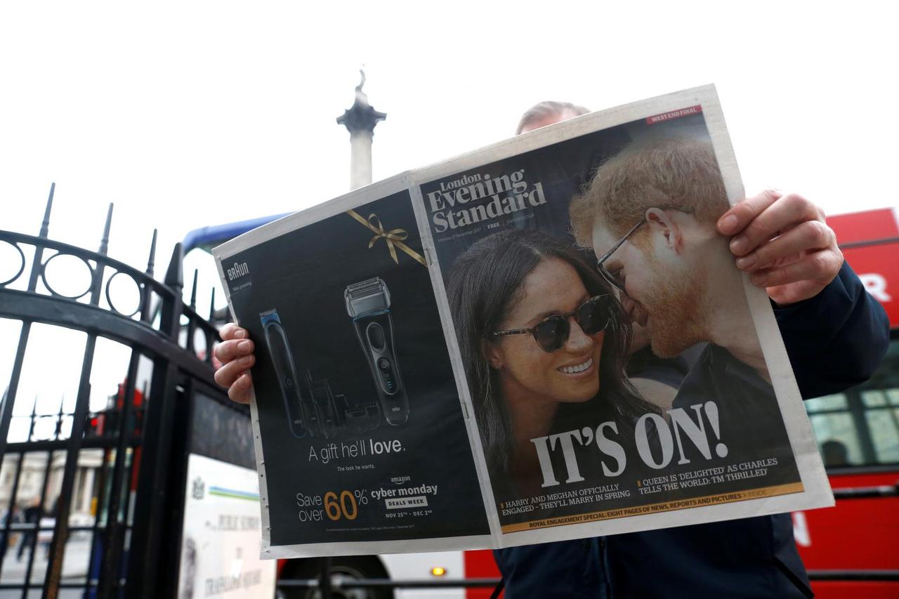 FILE PHOTO: A person is seen reading the London Evening Standard with the news that Prince Harry has announced his engagement to Meghan Markle, London