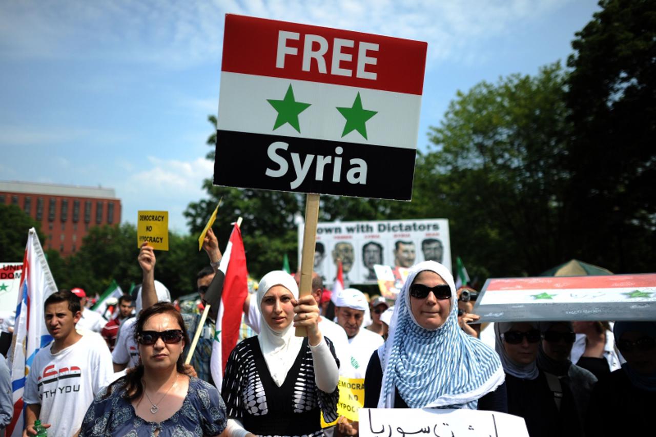 'Protesters shout slogans during a demonstration against the Syrian government in front of the White House in Washington, DC, on July 23, 2011. Several hundreds of protester took part in the demonstra
