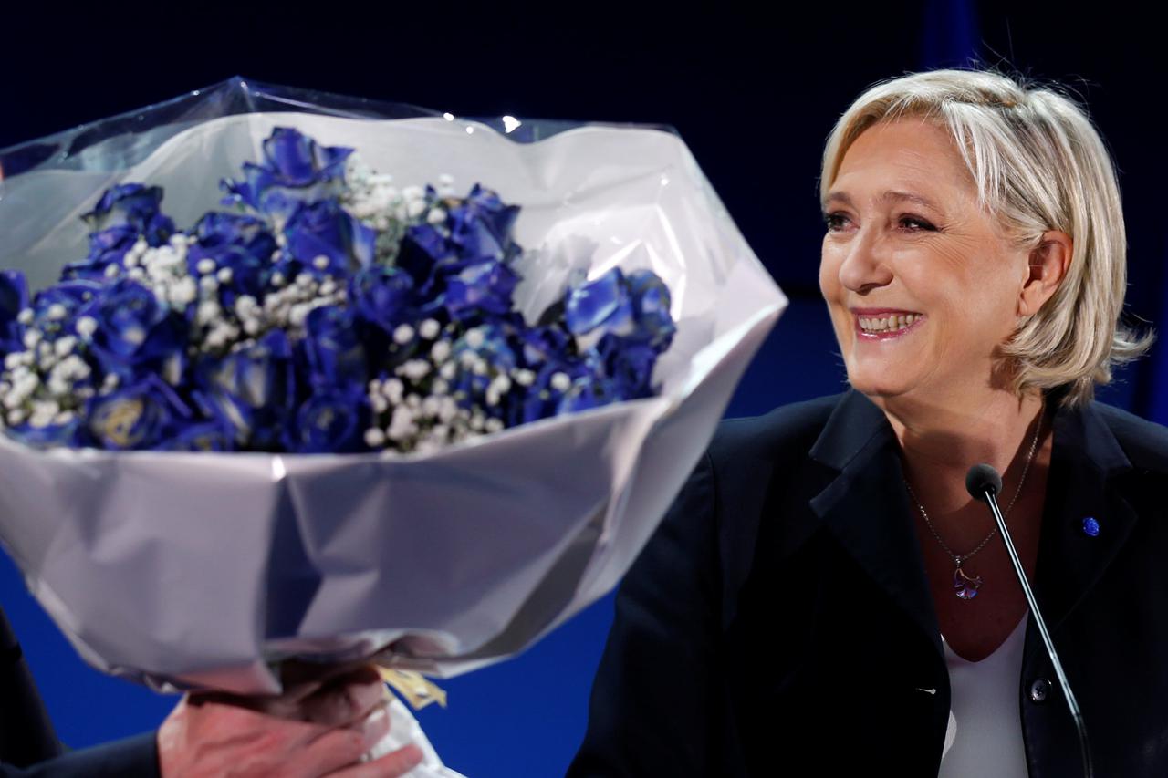 Marine Le Pen, French National Front (FN) political party leader and candidate for French 2017 presidential election, holds a bouquet of flowers as she celebrates after early results in the first round of 2017 French presidential election, in Henin-Beaumo