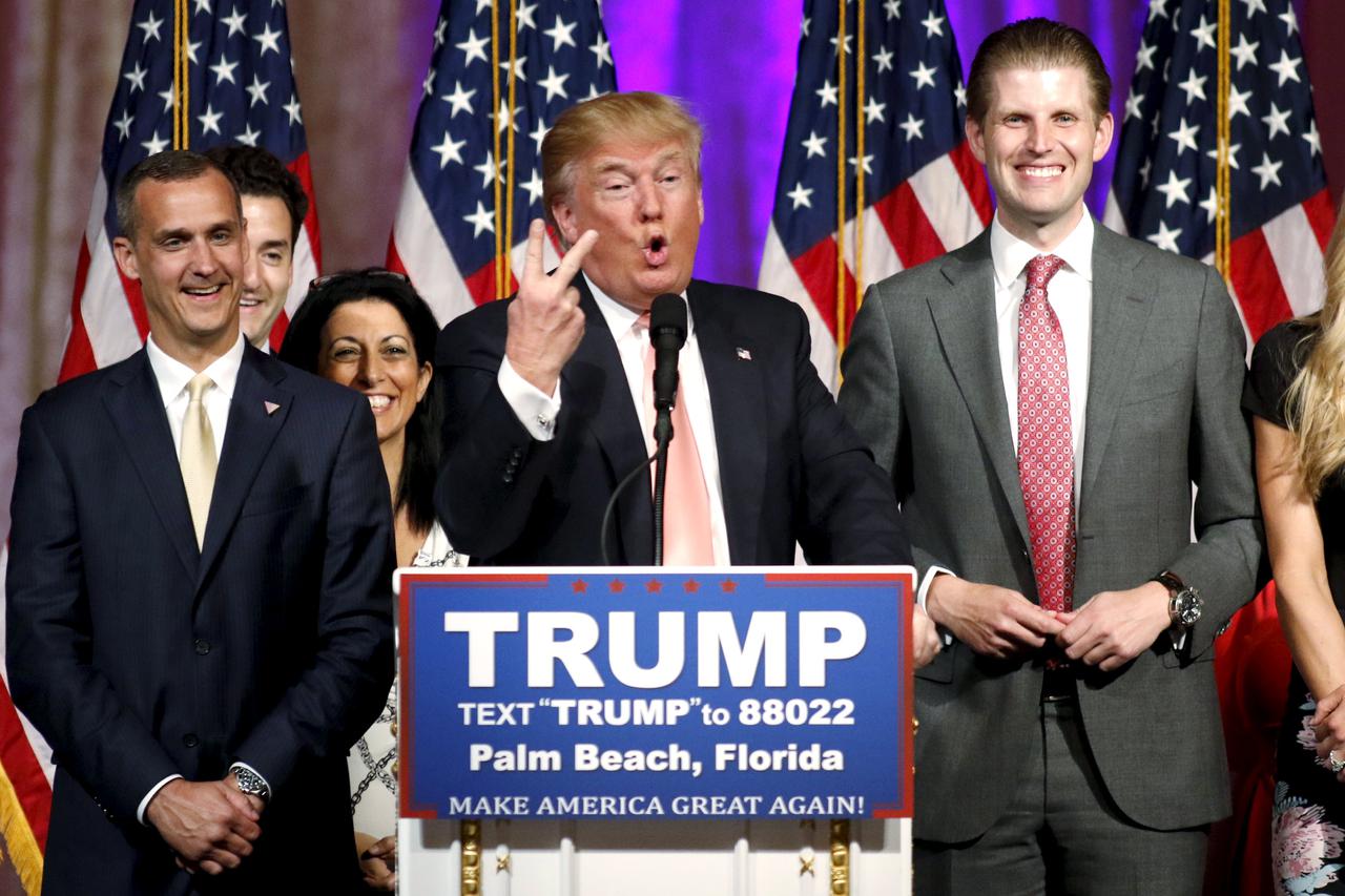 Republican U.S. presidential candidate Donald Trump stands between his campaign manager Corey Lewandowski (L) and his son Eric (R) as he speaks about the results of the Florida, Ohio, North Carolina, Illinois and Missouri primary elections during a news c