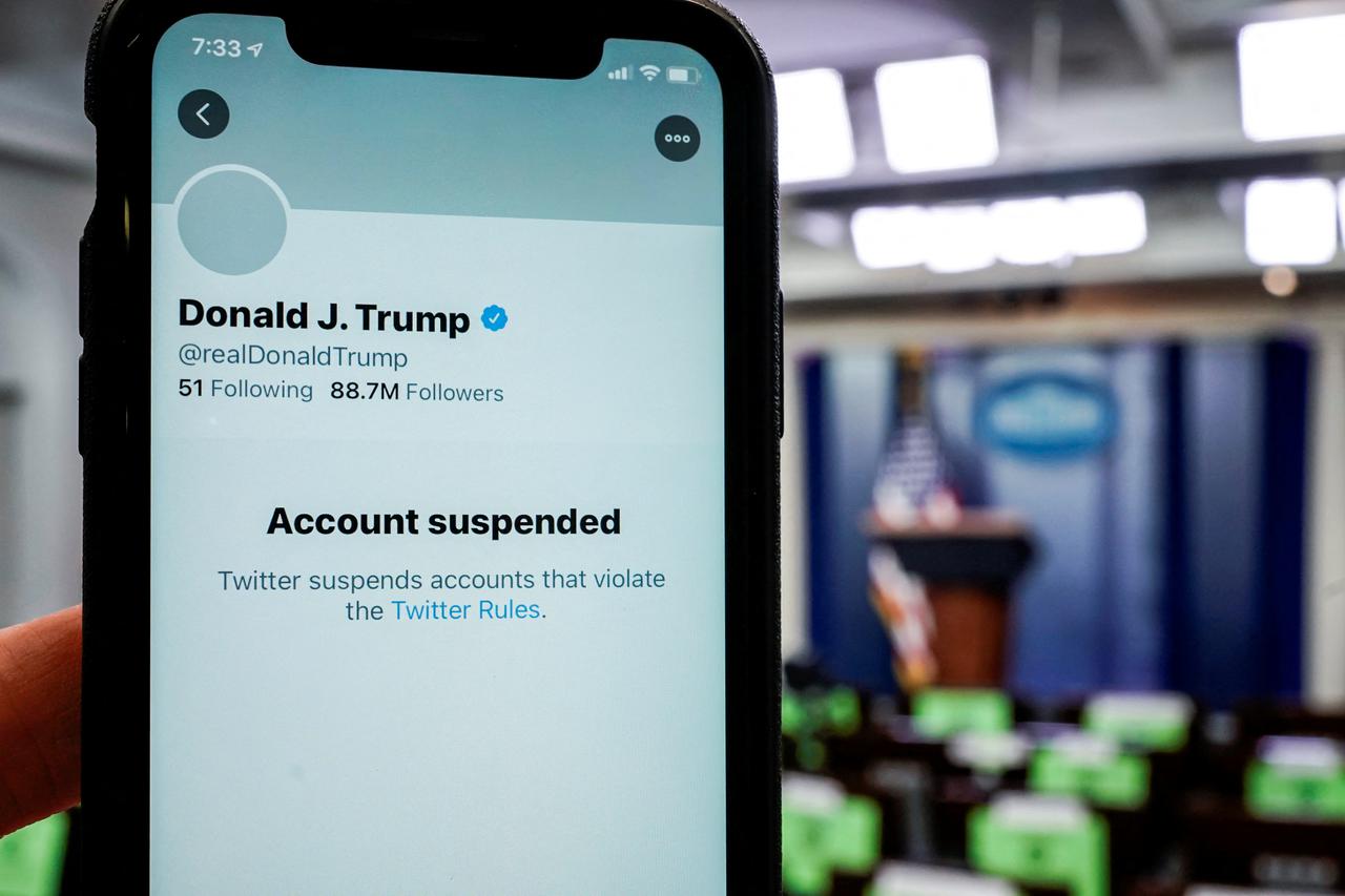 FILE PHOTO: A photo illustration shows the suspended Twitter account of U.S. President Donald Trump on a smartphone at the White House briefing room in Washington