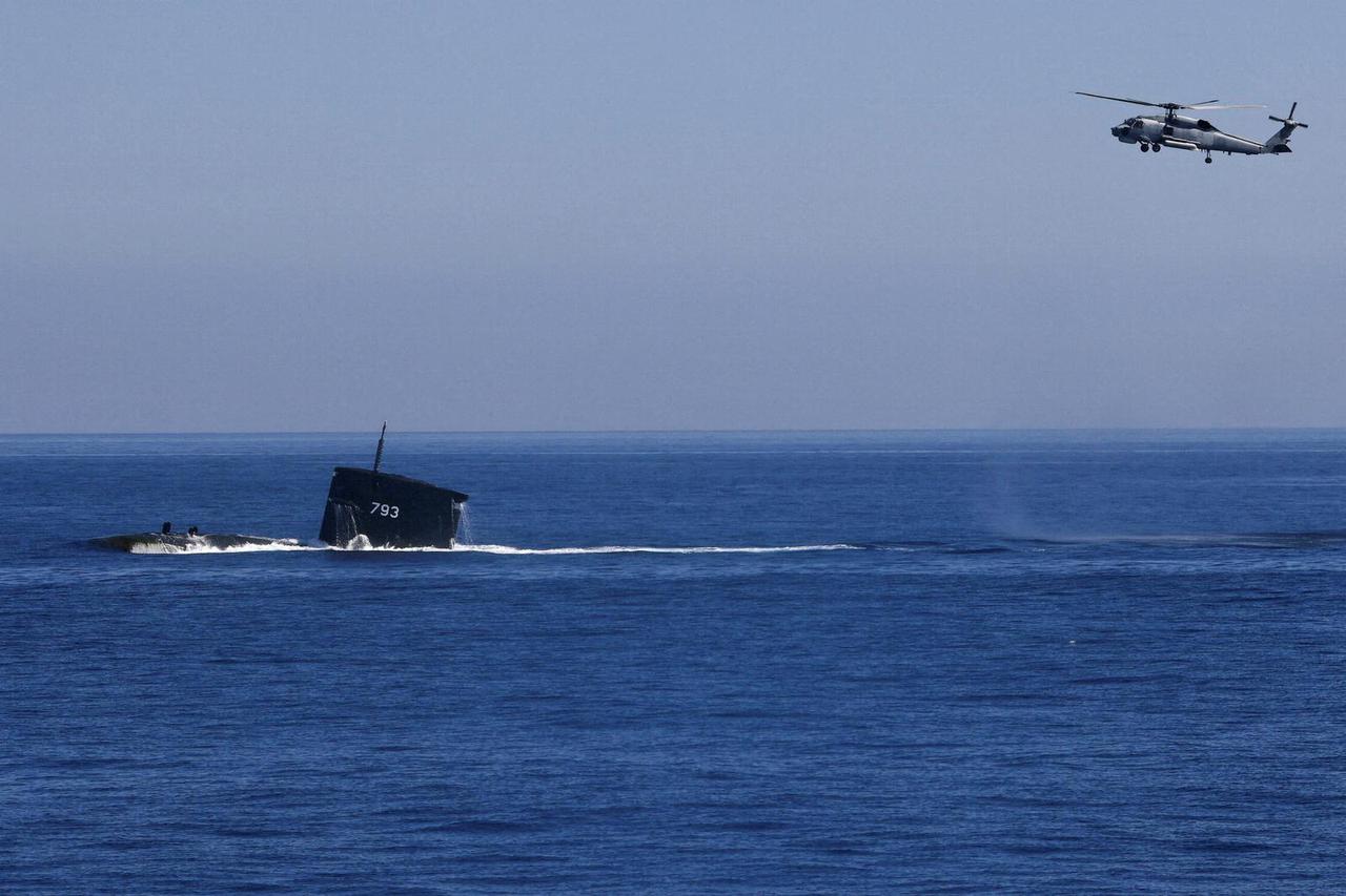 FILE PHOTO: A S70C helicopter can be seen flying around SS793 Submarine as part of Taiwan's main annual "Han Kuang" exercises