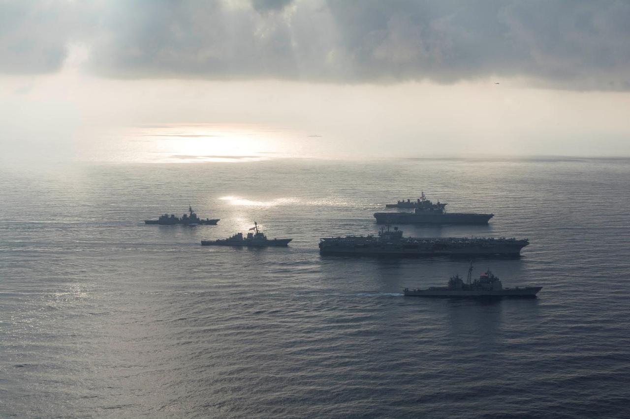 FILE PHOTO: The Ronald Reagan Strike Group ship's aircraft carrier USS Ronald Reagan conduct an exercise with the Japanese Maritime Self-Defense Force ships