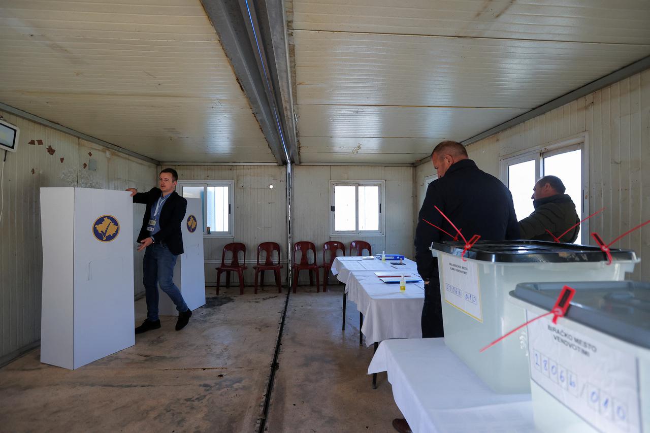 Members of the central election commission prepare a container used as an alternative voting center, in Zubin Potok