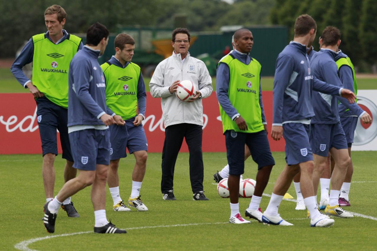 'England manager Fabio Capello (C) attends a team training session in London Colney, north of London May 31, 2011. England are due to play Switzerland in a Euro 2012 qualifier in London on June 4, 201