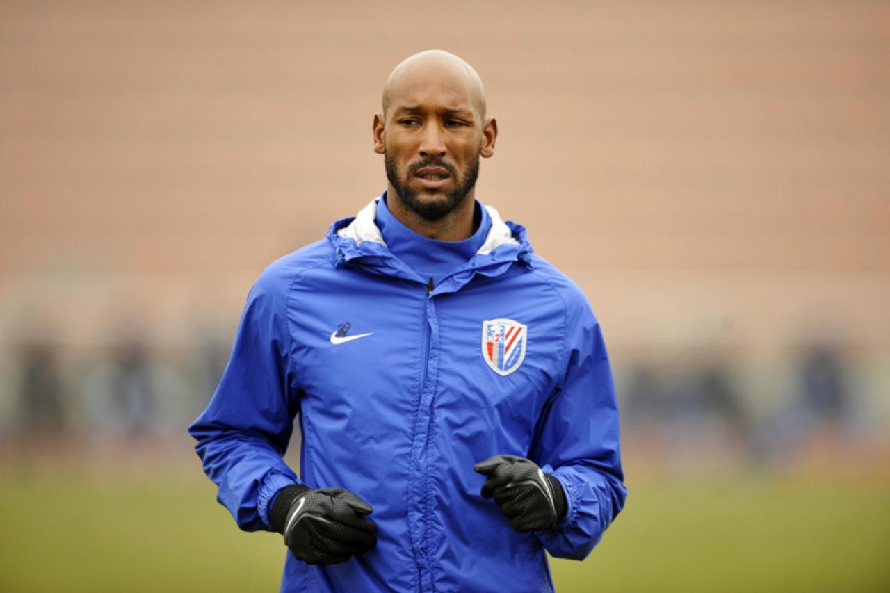 'French striker Nicolas Anelka warms up before his team Shanghai Shenhua plays in a friendly match against Hunan Xiangtao at their training ground in Shanghai on February 21, 2012.  Anelka has also ex