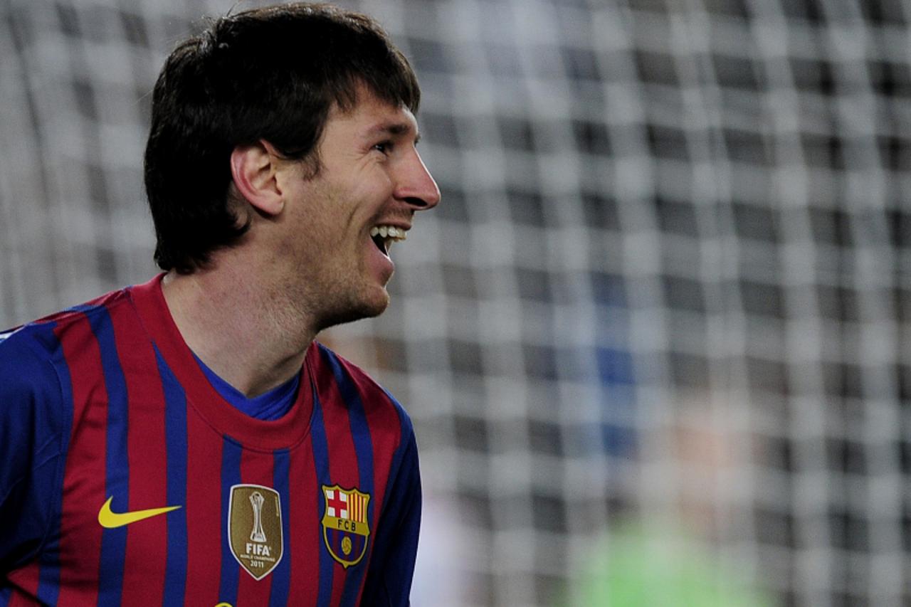 'Barcelona\'s Argentinian forward Lionel Messi celebrates a goal during the Champions League round of sixteen second leg football match between FC Barcelona vs Bayer 04 Leverkusen on March 7, 2012 at 