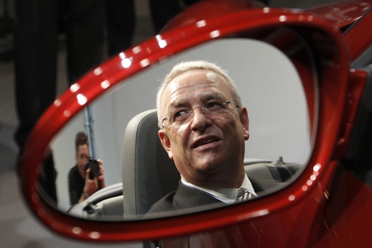 Volkswagen AG's Chief Executive Officer Martin Winterkorn is reflected in a mirror as he sits in a Porsche 911 Carrera Sports Car after the company's annual news conference in Stuttgart, Germany, in this March 17, 2011 file photo. Winterkorn faces a recko