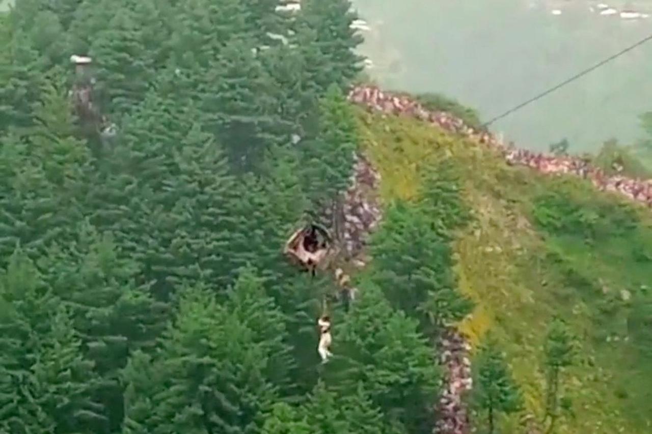 A helicopter rescues a person following a cable car with students stranded mid-air in Battagram