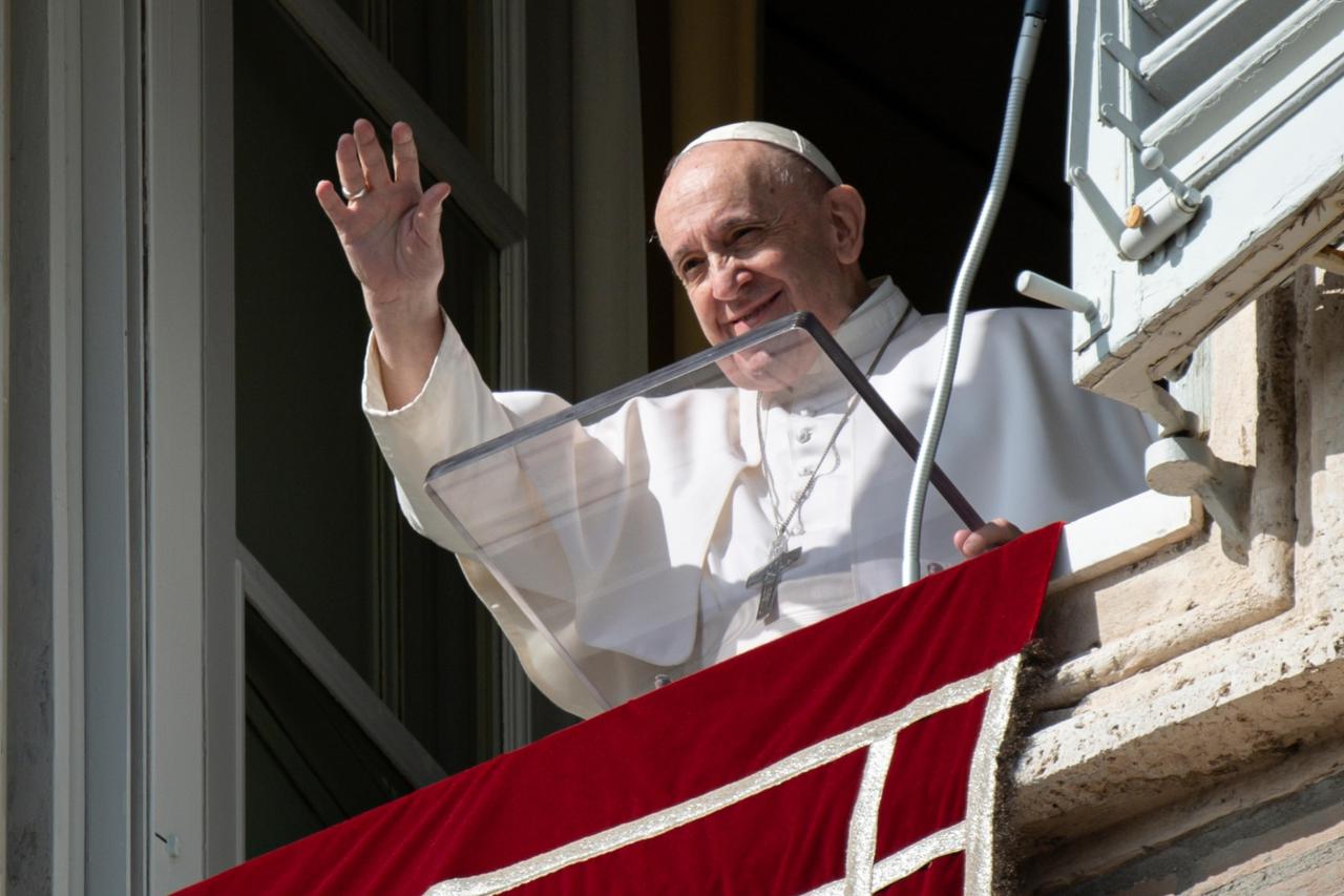 Pope Francis delivers his blessing during the Angelus