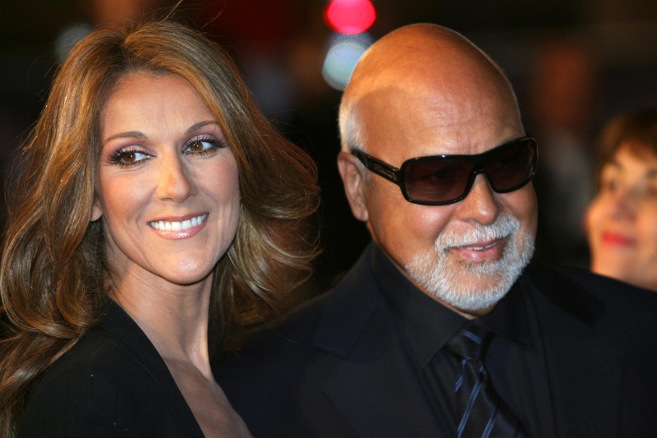 '(FILES) Canadian singer Celine Dion and husband Rene Angelil pose upon arrival at the Palais des Festivals in Cannes, southern France, 26 January 2008 to attend the 2008 NRJ Music Awards.  Dion is 14