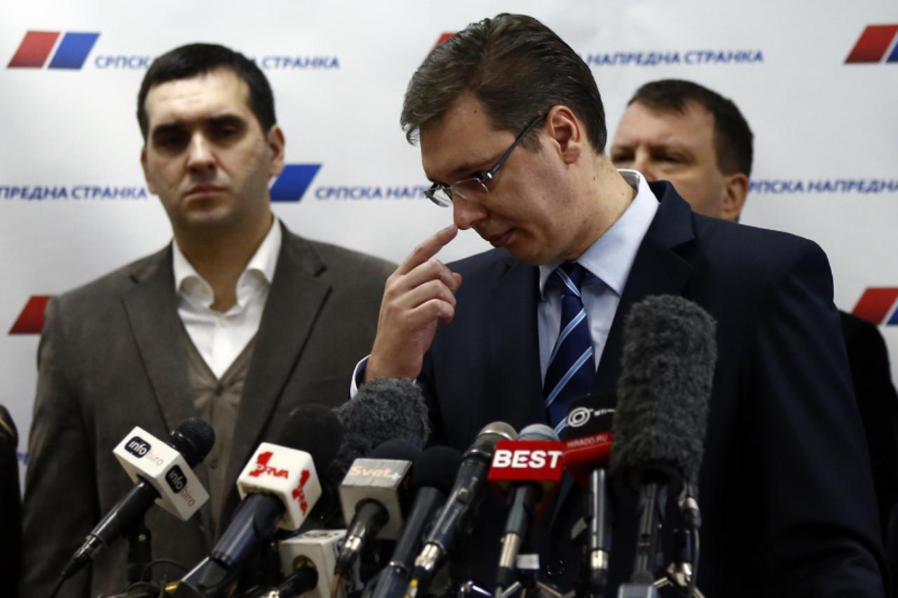 'Serbian Progressive Party (SNS) leader and Serbian defence Minister Aleksandar Vucic (C) gestures during a media conference in his party's headquarters in Belgrade February 4, 2013. Analysts said Se