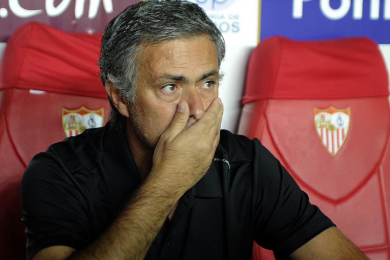 'Real Madrid\'s coach Jose Mourinho reacts during the Spanish league football match between Sevilla FC and Real Madrid at the Sanchez Pizjuan stadium in Sevilla on September 15, 2012.AFP PHOTO/ CRISTI