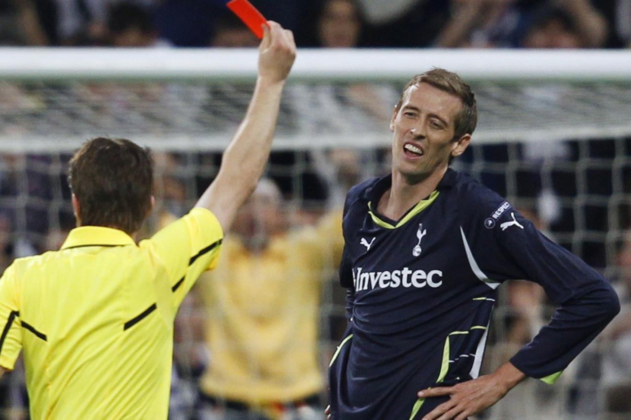 'Tottenham Hotspur\'s Peter Crouch (R) receives a red card from referee Felix Brych of Germany during the first leg of their Champions League quarter-final soccer match against Real Madrid at Santiago