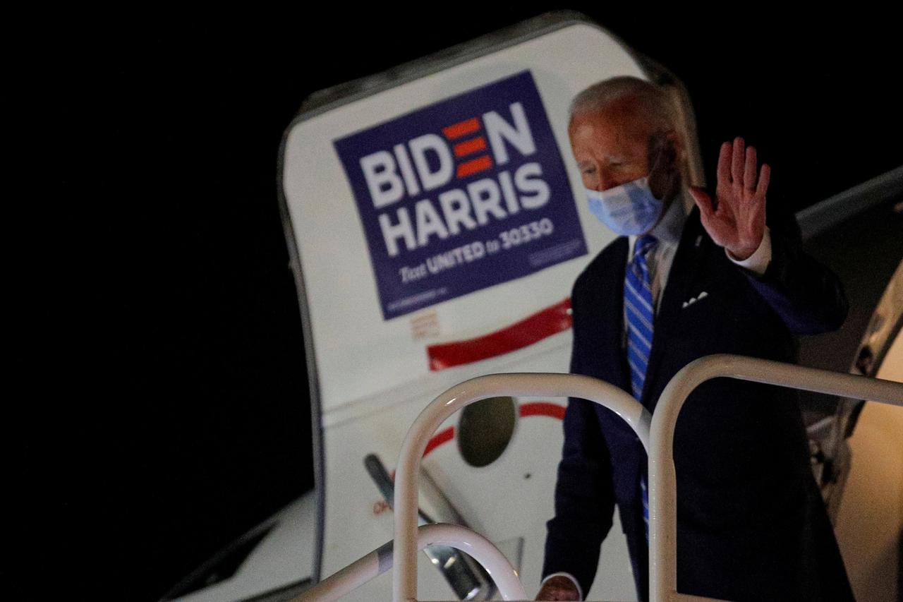 U.S. Democratic presidential candidate Joe Biden exits his campaign plane after campaigning in Miami, at New Castle Airport in New Castle, Delaware