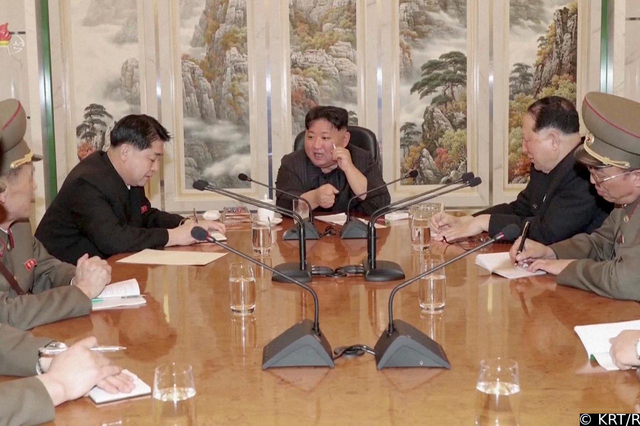 North Korean leader Kim Jong Un speaks with officials at an undisclosed location