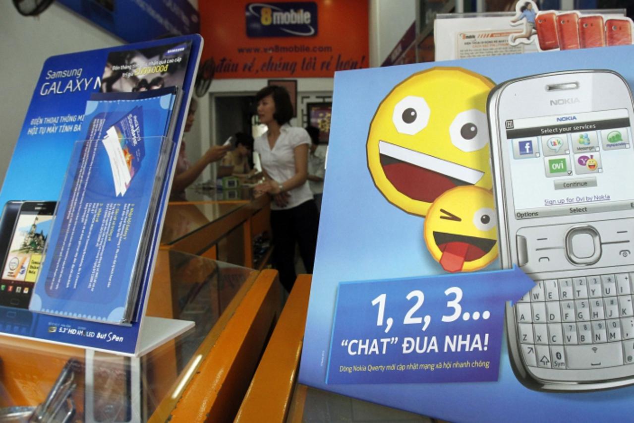 'Samsung and Nokia\'s advertisements are displayed at a shop in Hanoi April 13, 2012. Samsung Electronics Co Ltd will overtake Nokia Oyj as the No 1 cellphone manufacturer in a slowing global handset 