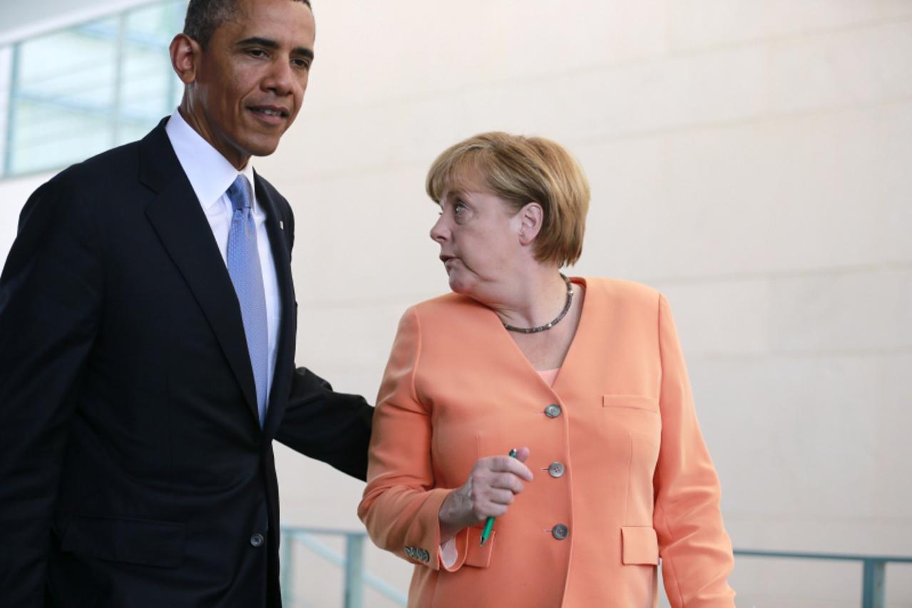 'File photo of U.S. President Barack Obama and German Chancellor Angela Merkel (R) making their way to a news conference at the Chancellery in Berlin June 19, 2013. U.S. President Barack Obama knew si