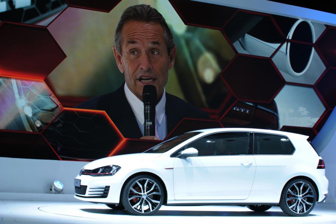'Motorsport legend Jacky Ickx (on screen) talks during the presentation of the Volkswagen Golf GTI on the stand of German carmaker Volkswagen on September 27, 2012 on the first of the two press days a