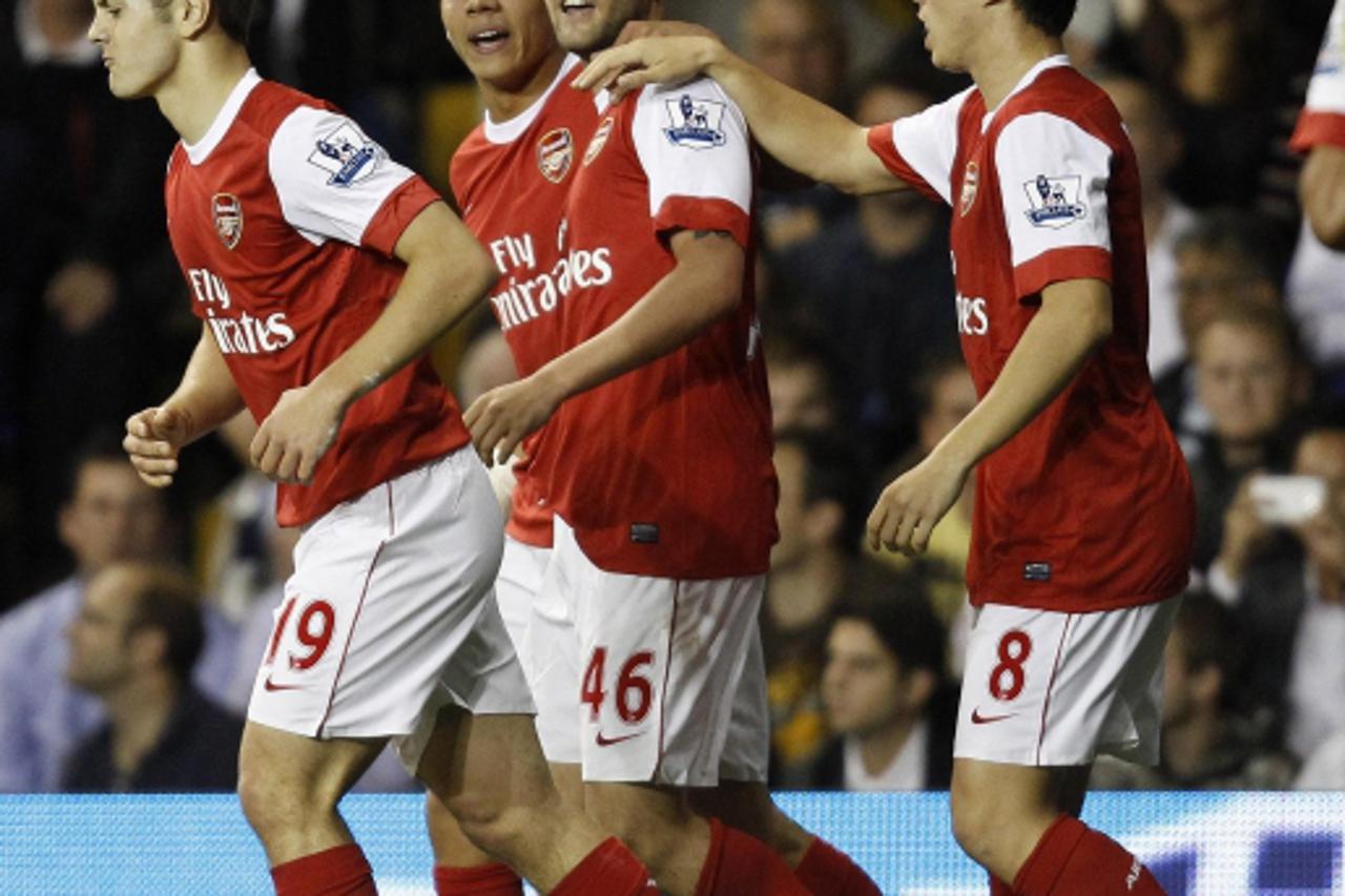 \'Arsenal\'s Henri Lansbury (C) celebrates with team mates after scoring against Tottenham Hotspur during their English League Cup soccer match at White Hart Lane in London September 21, 2010.   REUTE