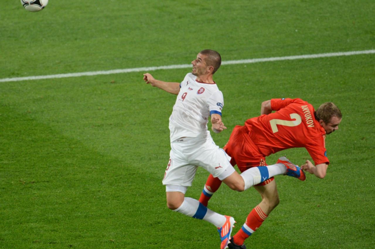 'Czech forward Jan Rezek (L) vies with Russian defender Aleksander Anyukov during the Euro 2012 football match Russia vs. Czech Republic, on June 8, 2012 at the Municipal stadium in Wroclaw. AFP PHOTO