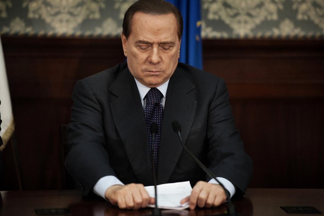 'Italian prime minister Silvio Berlusconi gestures during a press conference in Naples on November 26, 2010.  Berlusconi made a statement on Naples\' latest garbage emergency. An EU team of inspectors