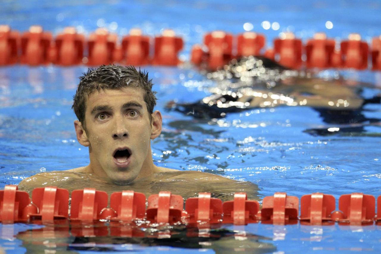 'Michael Phelps of the U.S. reacts after the men\'s 200m freestyle final at the 14th FINA World Championships in Shanghai July 26, 2011.        REUTERS/Christinne Muschi (CHINA  - Tags: SPORT SWIMMING