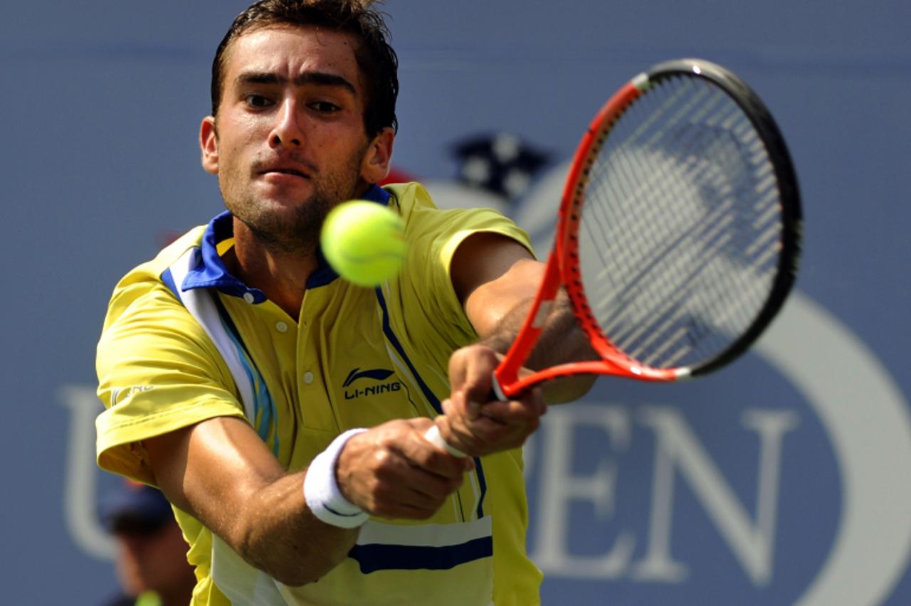 'Marin Cilic of Croatia plays against Roger Federer of Switzerland (3) during their Men\'s match at the USTA Billie Jean King National Tennis Center in New York on September 3, 2011.    AFP PHOTO / TI