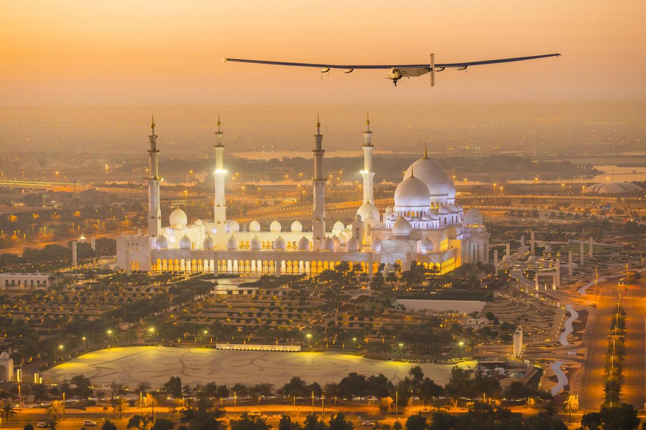 The Solar Impulse 2, a solar-powered plane, flies over the Sheikh Zayed Grand Mosque in Abu Dhabi during preparations for next month's round-the-world flight, February 26, 2015. Swiss pilots Bertrand Piccard and Andre Borschberg will attempt to fly around