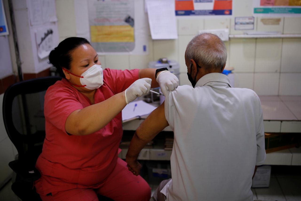 Kailash Nath, 69, receives a dose of COVISHIELD vaccine, a coronavirus disease (COVID-19) vaccine, manufactured by Serum Insitutue of India, at a hospital, in New Delhi