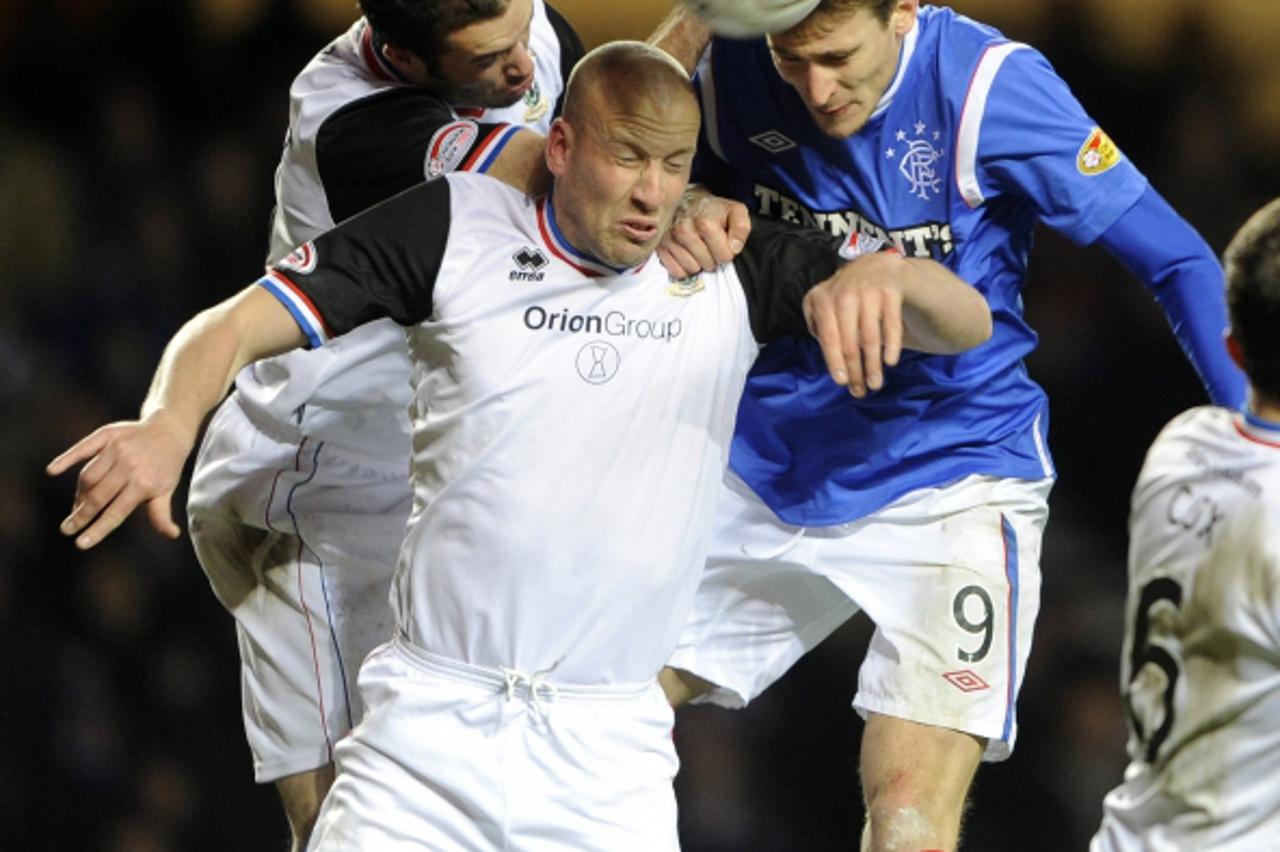 'Inverness Caledonian Thistle\'s Roman Golobart (L) and Ross Tokely challenge Rangers\' Nikica Jelavic (R) during their Scottish Premier League soccer match at Ibrox Stadium, Glasgow, Scotland, Decemb