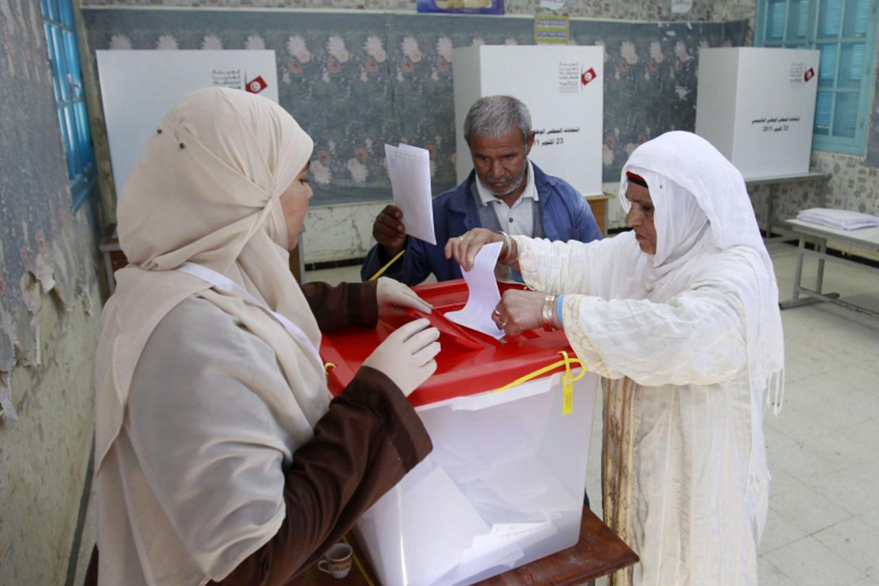 'A Tunisian woman casts her ballot at a polling station during an election in Sidi Bouzid October 23, 2011. The election, the first free vote in Tunisia\'s history, will set a standard for other Arab 