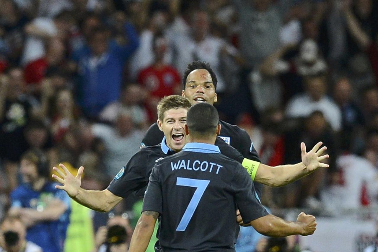 'England\'s Theo Walcott is congratulated after scoring his team\'s second goal against during their Group D Euro 2012 soccer match at the Olympic stadium in Kiev, June 15, 2012.                REUTER