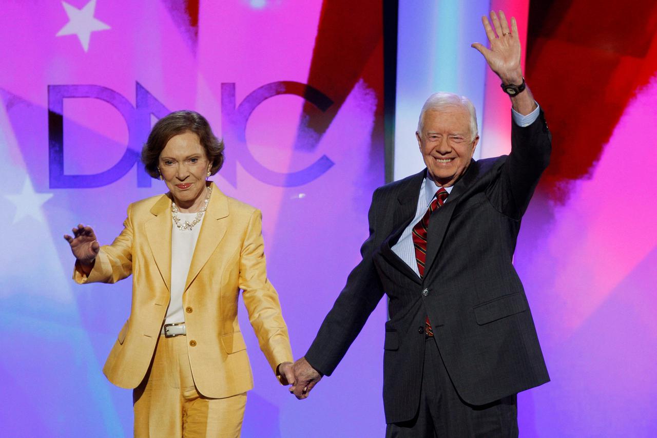 FILE PHOTO: Former U.S. President Carter and former first lady Rosalynn arrive onstage in Denver