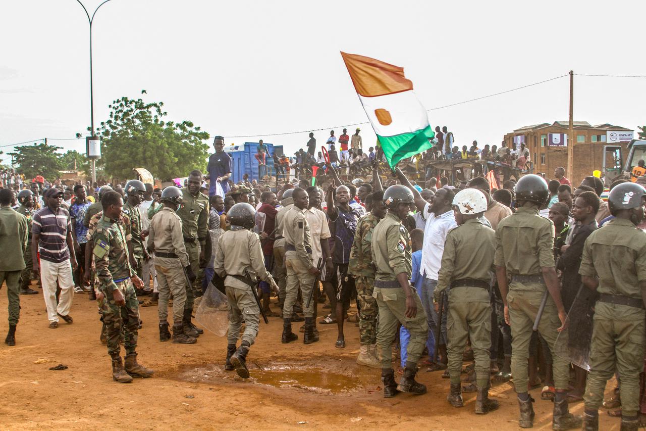 Niger's junta supporters take part in a demonstration in front of a French army base in Niamey,