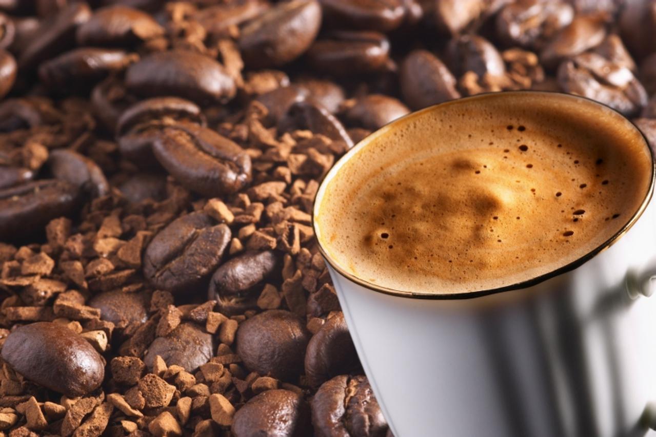 'cup of coffee over coffee-beans and instant coffee background'
