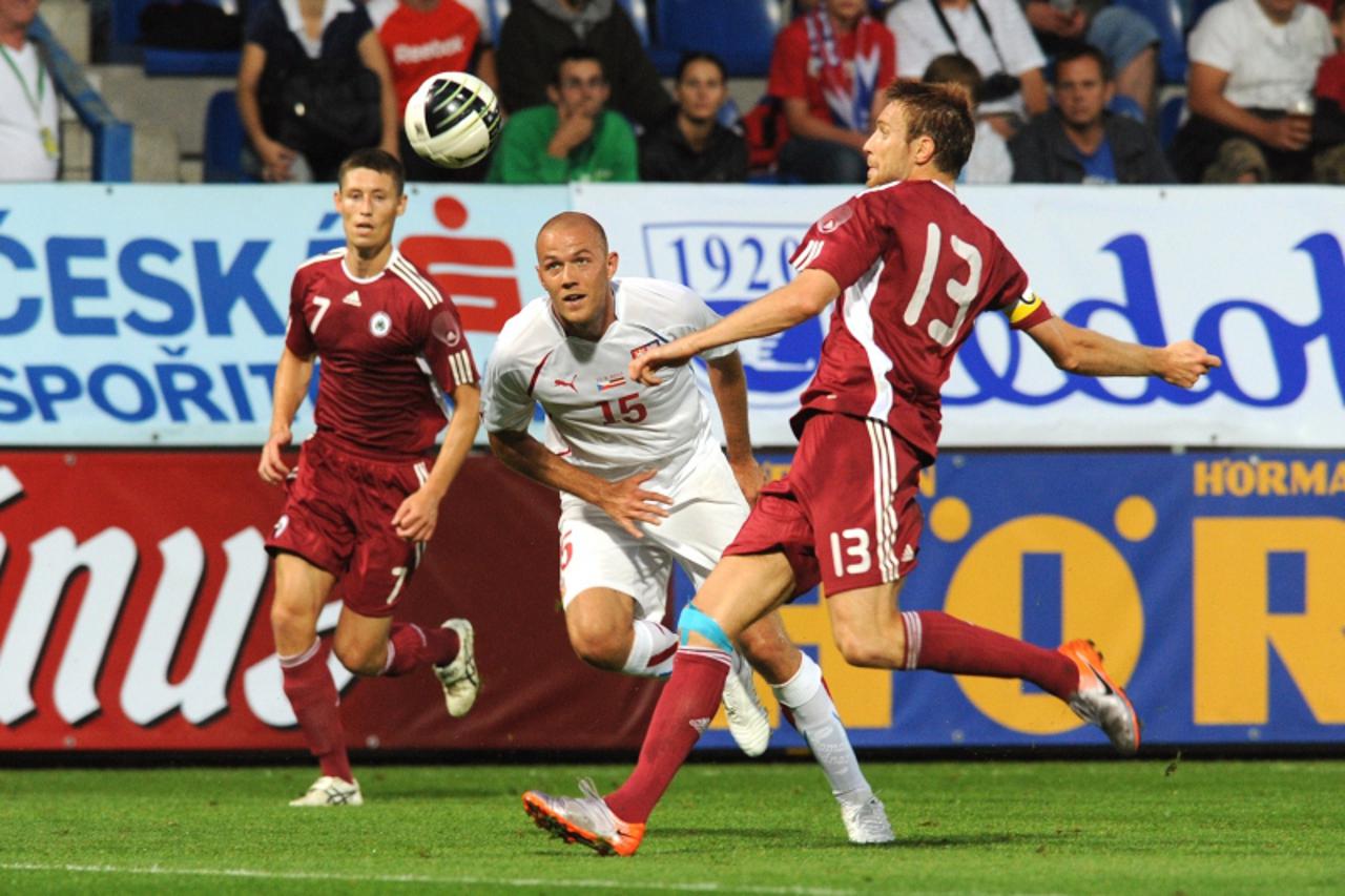 \'Kaspars Gorkss of Latvia (R) fights for ball with Roman Bednar (C) of Czech Republic during a friendly football match on August 11, 2010 in Liberec. AFP PHOTO MICHAL CIZEK\'