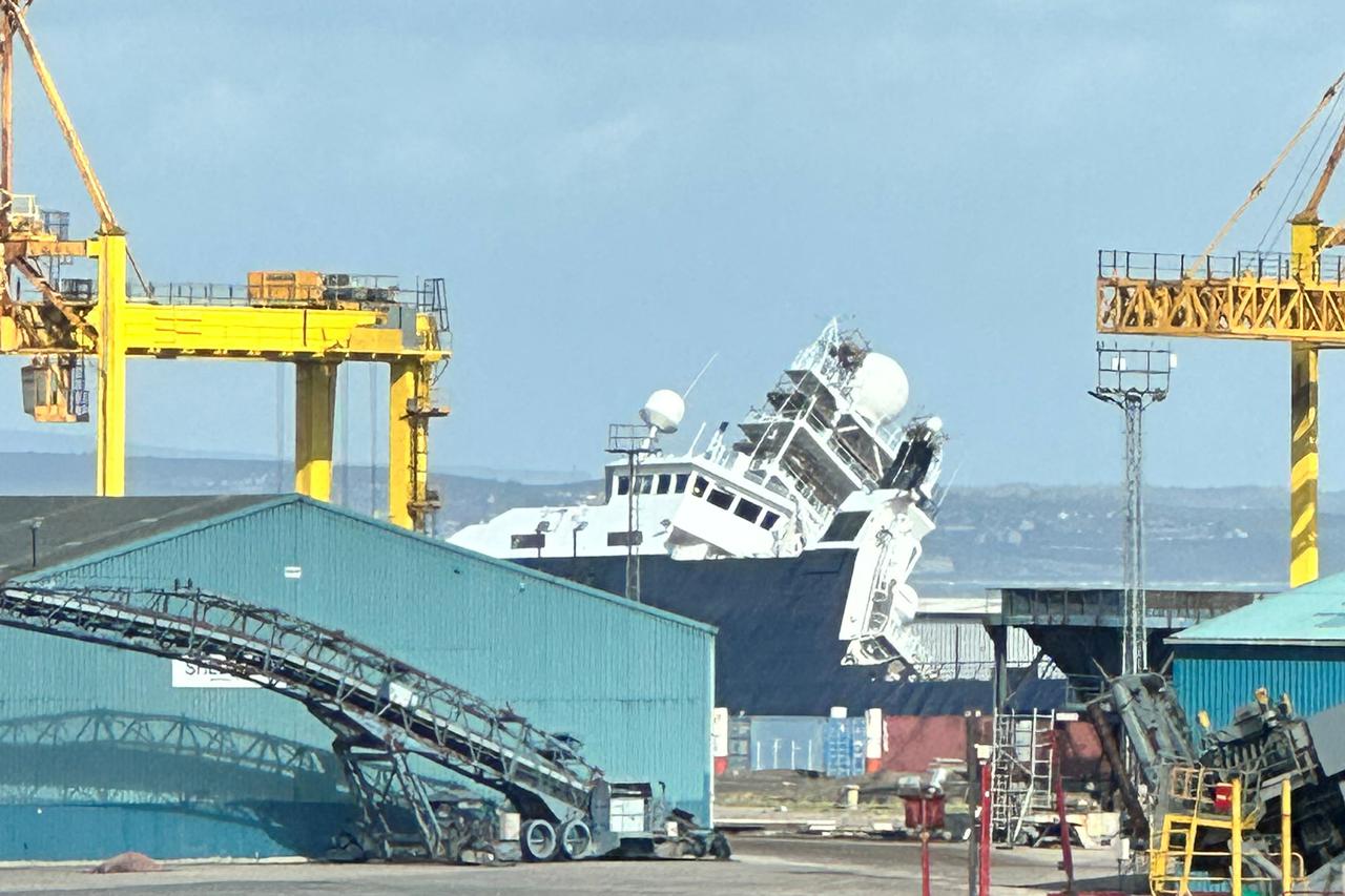Ship topples in dry dock in Leith, near Edinburgh