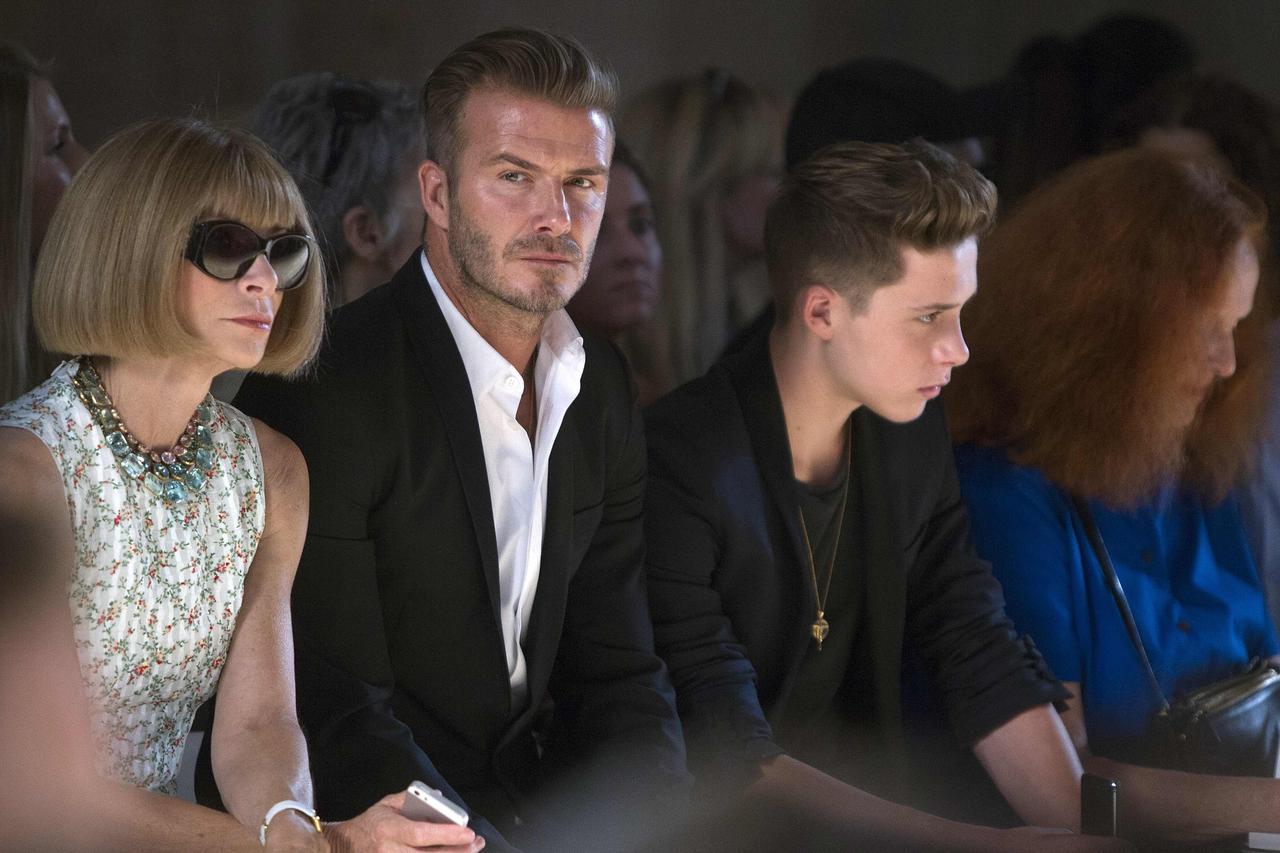 (L-R) Vogue editor Anna Wintour, David Beckham and his son Brooklyn Beckham watch a model present a creation during the Victoria Beckham Spring/Summer 2015 collection during New York Fashion Week in the Manhattan borough of New York September 7, 2014.    