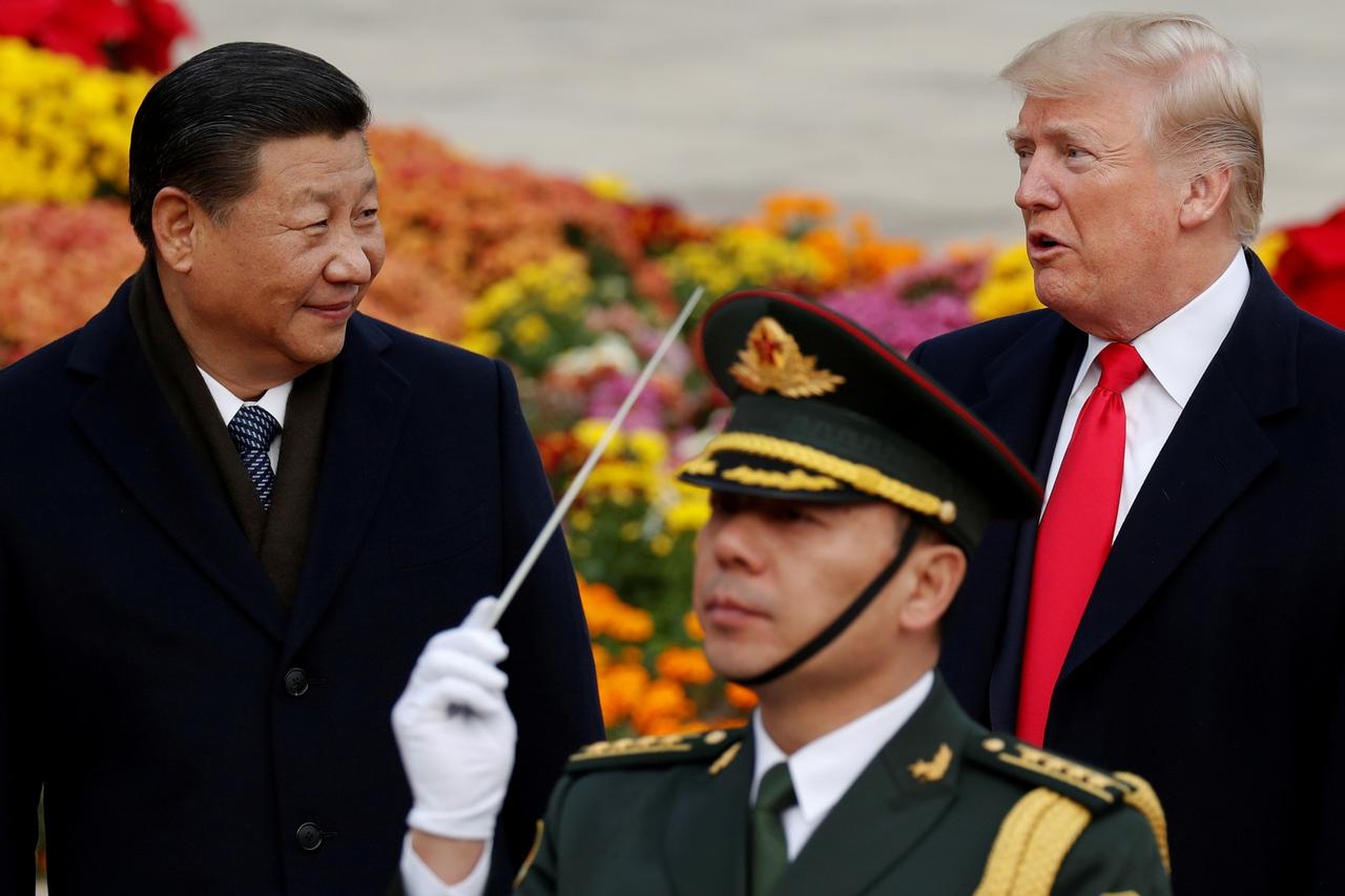 FILE PHOTO: U.S. President Donald Trump takes part in a welcoming ceremony with China's President Xi Jinping at the Great Hall of the People in Beijing