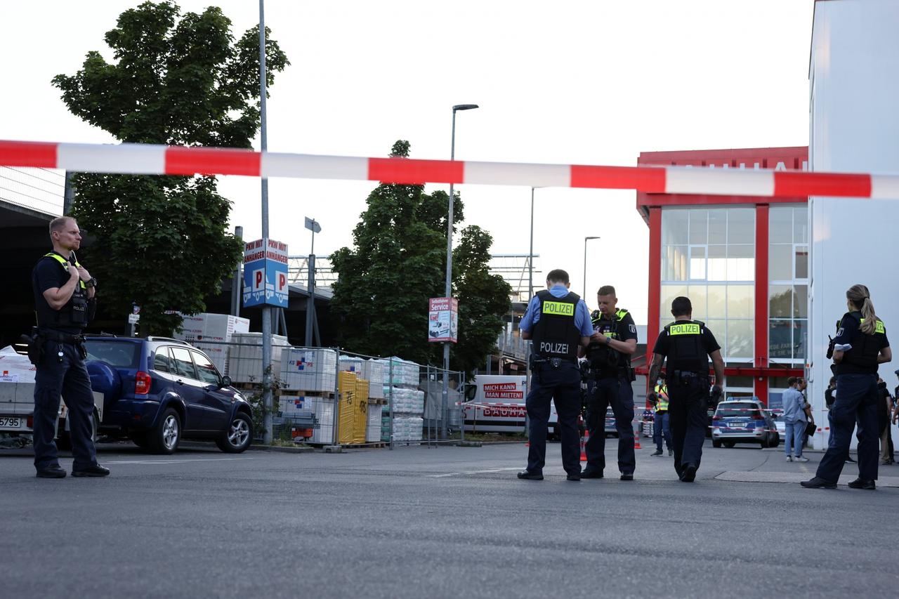 Police officers secure parking space after shots fired outside Berlin store