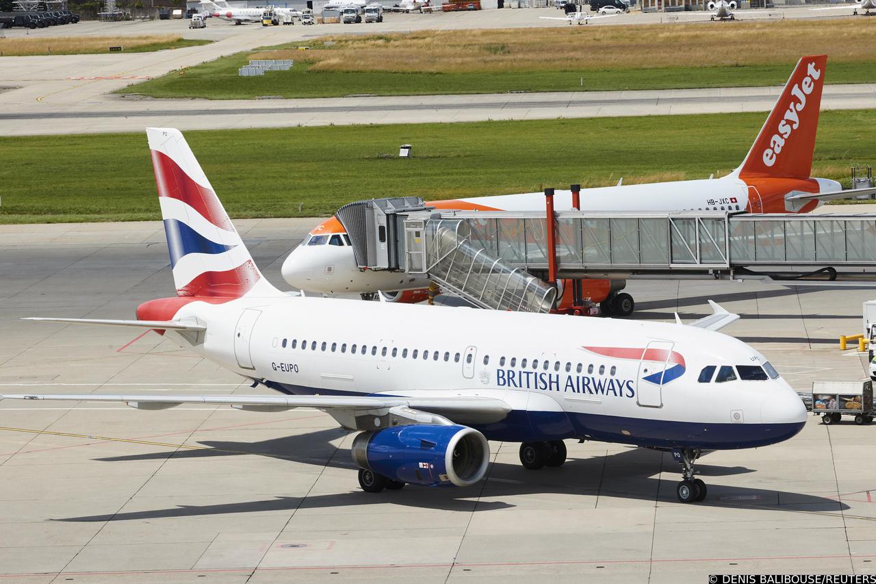 FILE PHOTO: A British Airways aircraft parks next to an EasyJet plane at Cointrin airport in Geneva