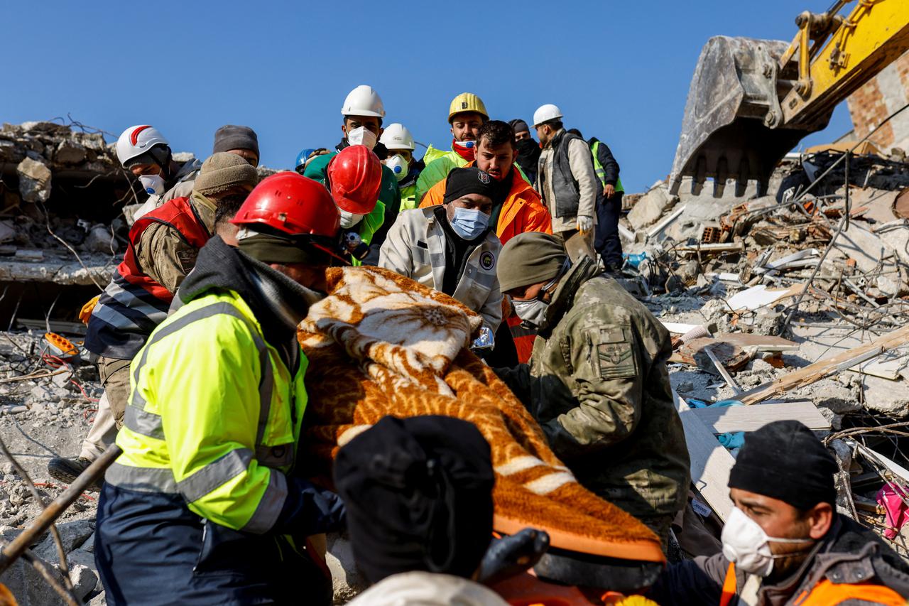 Rescuers carry survivor Muzeyyen Ofkeli in the aftermath of a deadly earthquake, in Hatay, Turkey