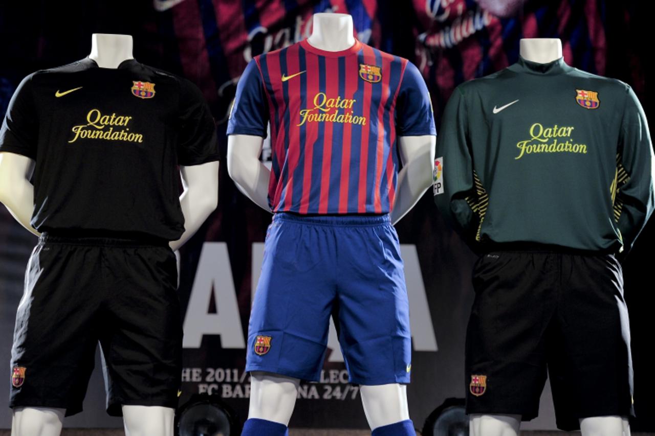 \'Mannequins are used to display Barcelona\'s new football team jersey featuring the name of the club\'s new sponsor the Qatar Foundation in Barcelona on May 17, 2011. The Qatar Foundation signed a re
