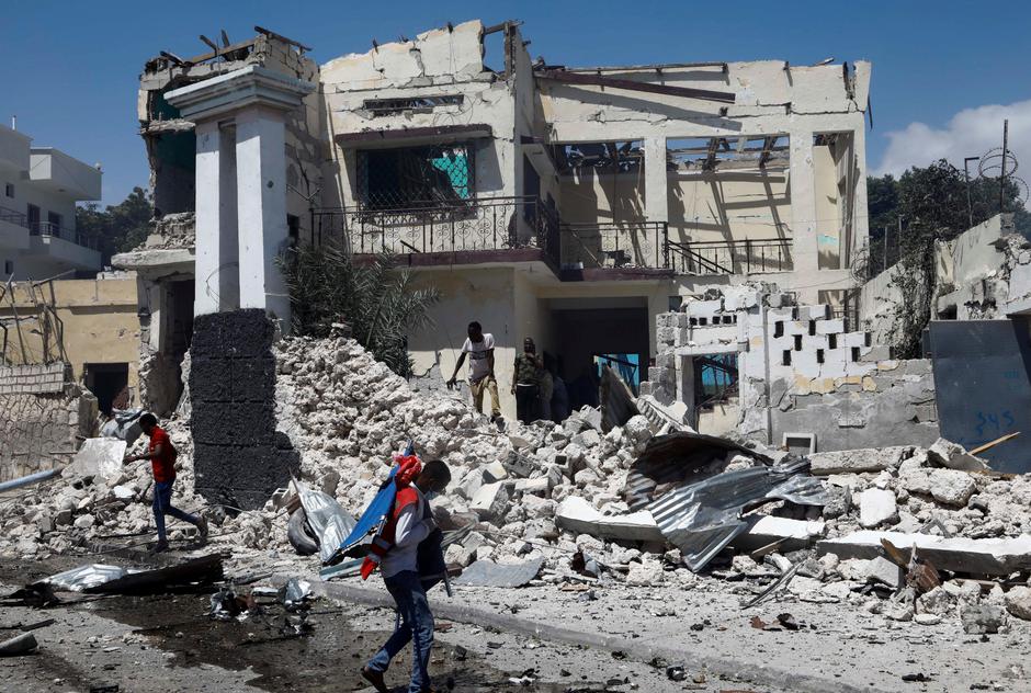 A paramedic walks past a ruined building near the scene of an explosion in the Hamarweyne district of Mogadishu