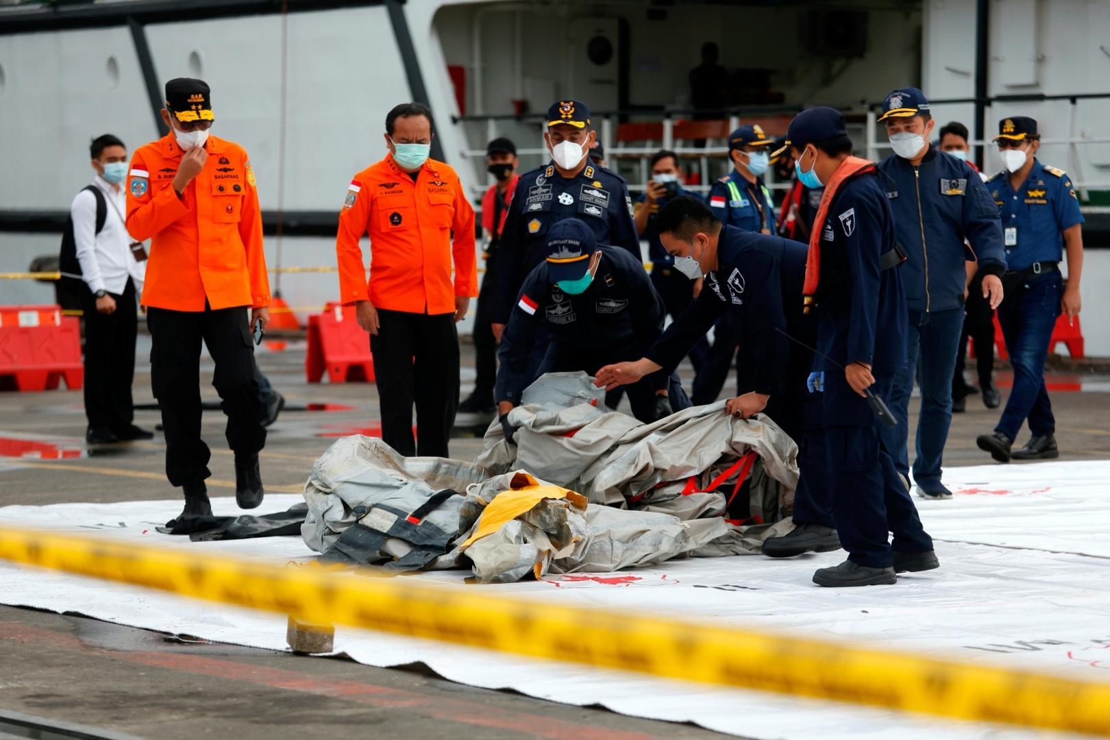 Indonesian rescue members carry what is believed to be the remains of the Sriwijaya Air plane flight SJ 182 which crashed into the sea, at Jakarta International Container Terminal port in Jakarta Indonesian rescue members carry what is believed to be the remains of the Sriwijaya Air plane flight SJ 182 which crashed into the sea, at Jakarta International Container Terminal port in Jakarta, Indonesia, January 10, 2021. REUTERS/Ajeng Dinar Ulfiana AJENG DINAR ULFIANA
