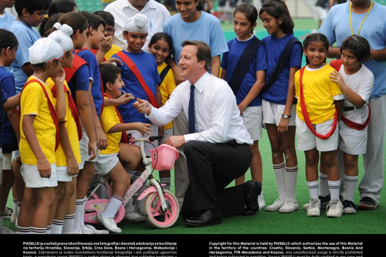 'Prime Minister David Cameron meets local school children at the Major Dhyan Chand National Hockey Stadium in Delhi, on the last day of a three day trip to India.Photo: Press Association/PIXSELL'